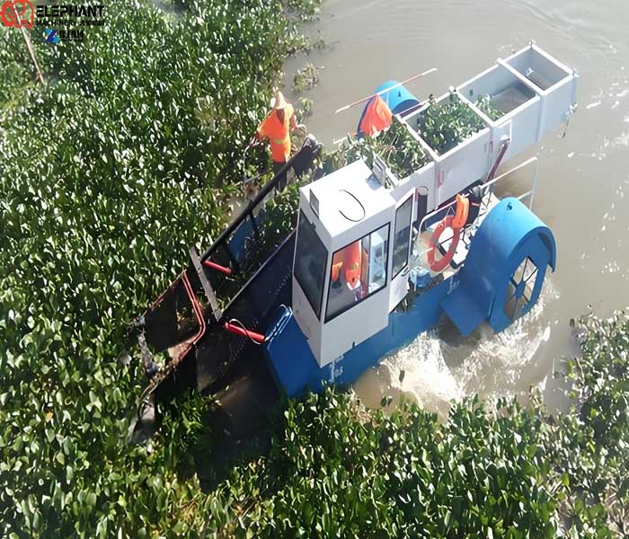aquatic weed harvester collecting vegetation from lake water