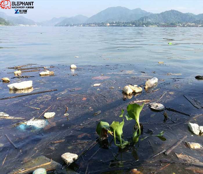 floating garbage and plastic waste accumulated on a river surface
