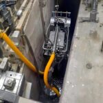 Confined space dredging robot removing sludge in a restricted-access area