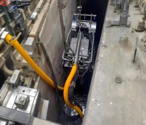 Confined space dredging robot removing sludge in a restricted-access area