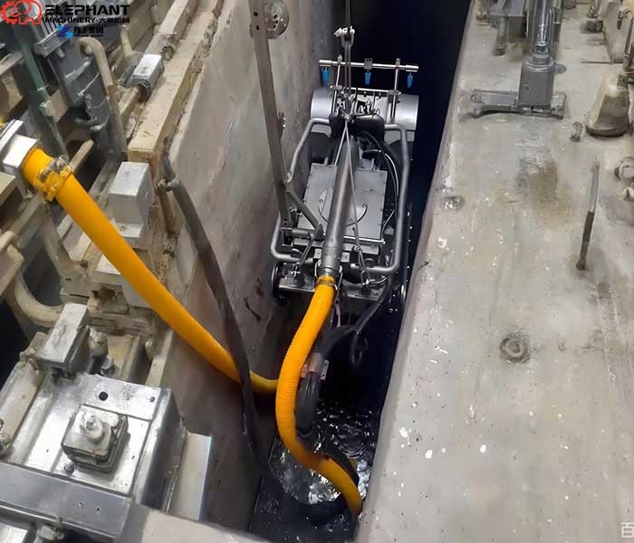 Confined space dredging robot removing sludge in a restricted-access area