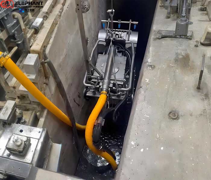 crawler dredging robot removing sludge from oxidation pond