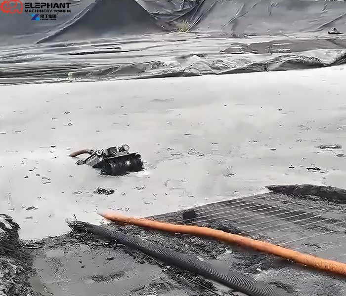 Manure lagoon cleaning robot removing settled organic sludge from a farm lagoon