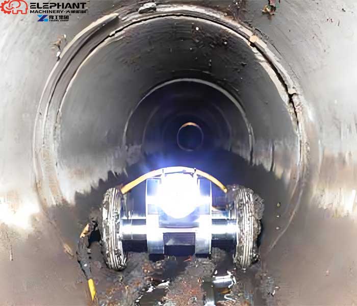 Pipe cleaning robot removing sludge buildup and sewage solids from underground pipelines