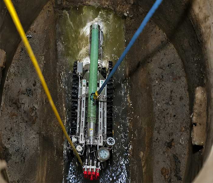 Remote-controlled pipe cleaning robot operated safely without human entry into confined spaces