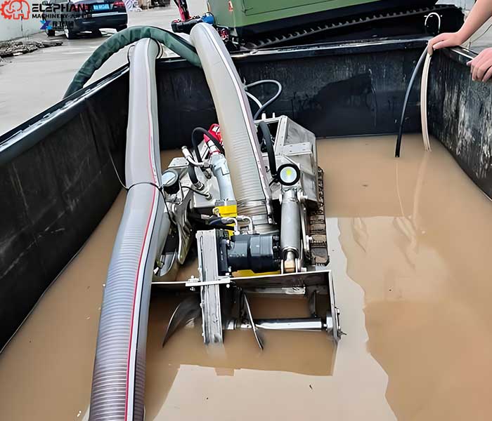 Robotic sludge removal system loosening accumulated sediment underwater