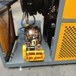Small storm drain cleaning robot removing sand and sediment from underground drainage system