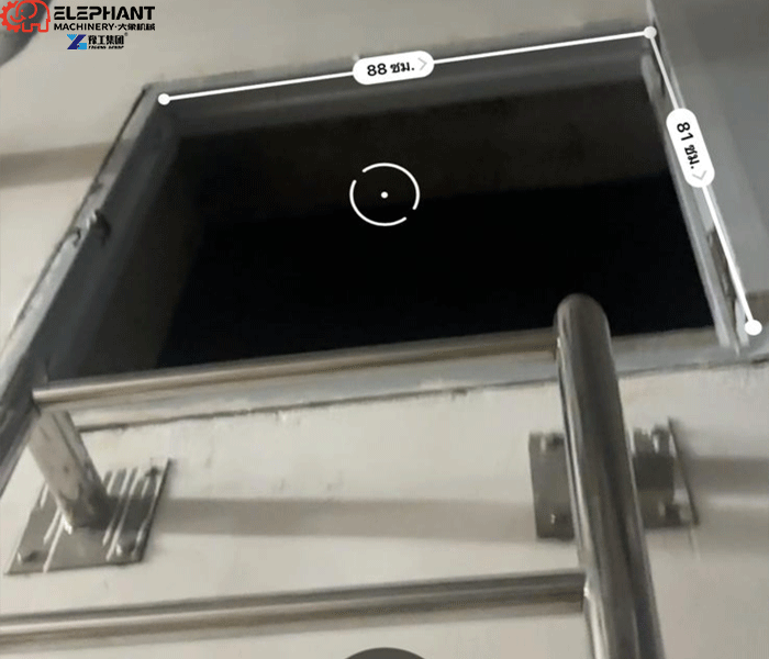 Dredging robot designed to enter industrial tanks through small access openings
