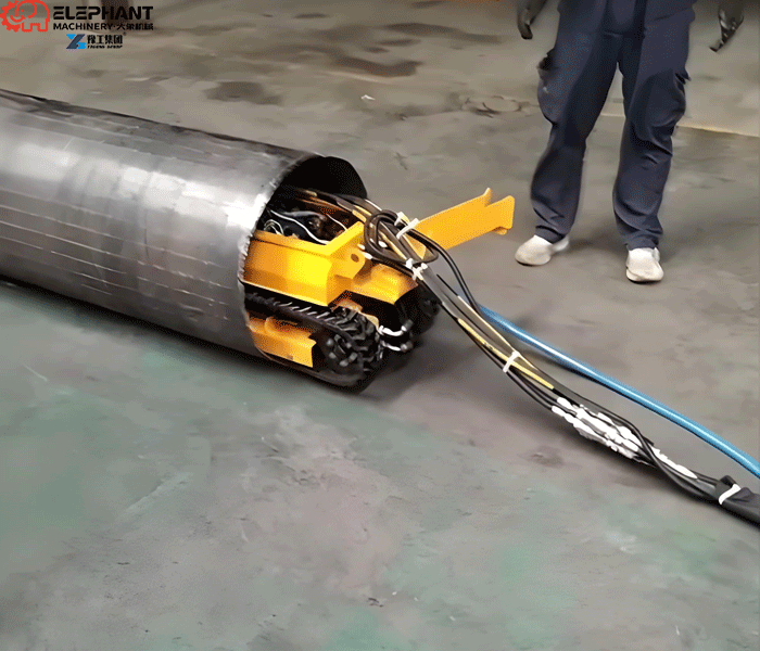 Robotic dredge operating inside an industrial tank to remove accumulated sludge