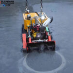 Remote-controlled robot removing sludge from a wastewater tank