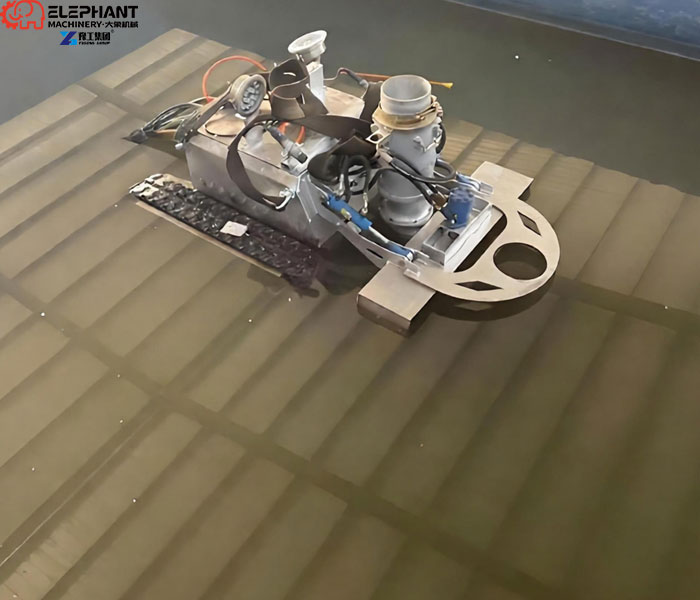 robot removing settled sludge from clarifier
